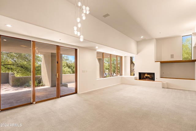 unfurnished living room featuring carpet flooring and a towering ceiling