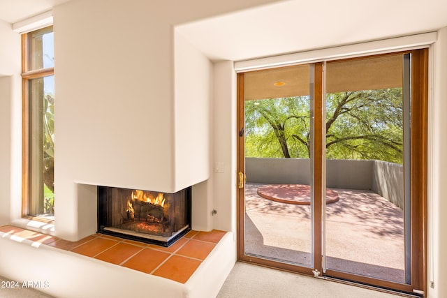 doorway with a fireplace and floor to ceiling windows