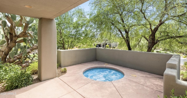 view of patio / terrace with an in ground hot tub