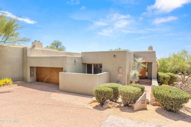 adobe home featuring a garage