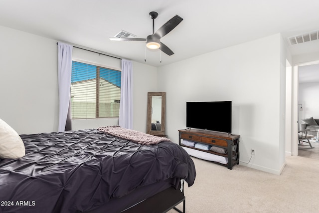 bedroom featuring light carpet and ceiling fan