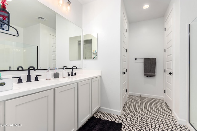 bathroom featuring walk in shower, tile patterned flooring, and vanity