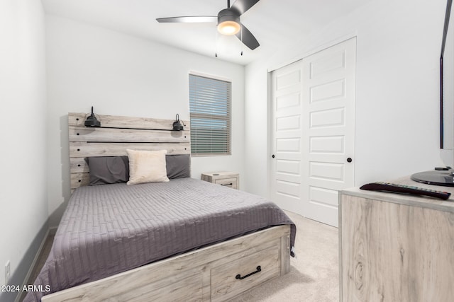 carpeted bedroom featuring a closet and ceiling fan