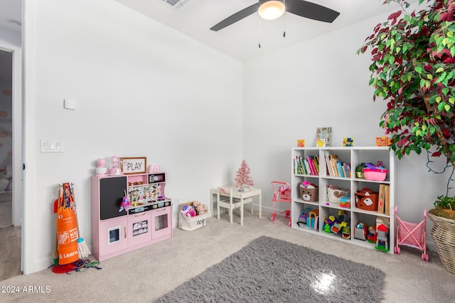 recreation room with ceiling fan and carpet