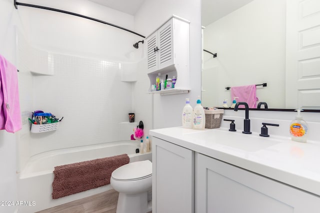 full bathroom featuring shower / bath combination, hardwood / wood-style flooring, toilet, and vanity