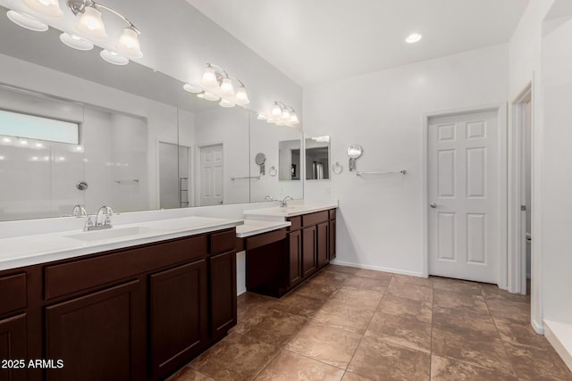 bathroom with baseboards and vanity