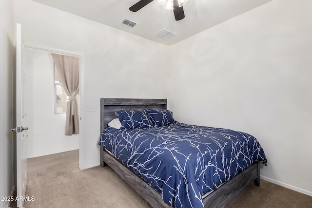 carpeted bedroom featuring visible vents, ceiling fan, and baseboards