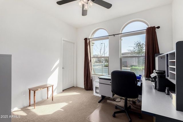 carpeted office featuring ceiling fan