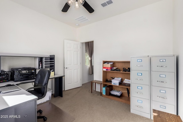 carpeted office featuring a ceiling fan, lofted ceiling, and visible vents