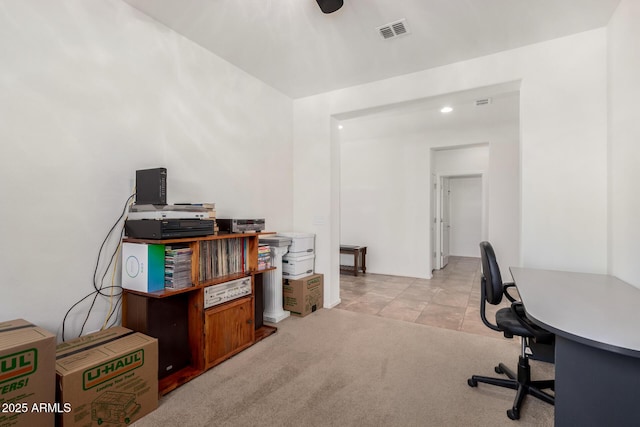 home office with visible vents and light carpet