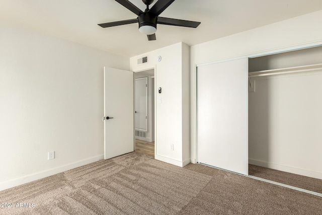 unfurnished bedroom with carpet flooring, ceiling fan, and a closet