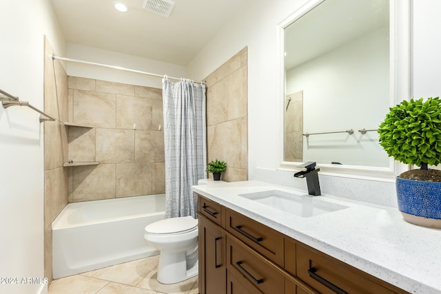 full bathroom featuring tile patterned flooring, toilet, vanity, and shower / tub combo with curtain