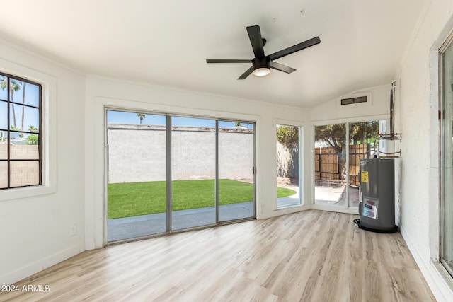 unfurnished sunroom featuring ceiling fan, lofted ceiling, and water heater