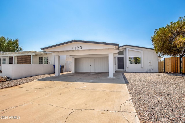 single story home with a carport