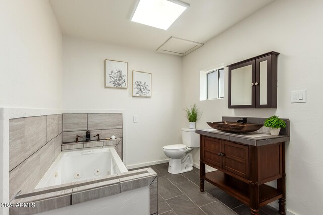 bathroom featuring tile patterned flooring, toilet, and vanity