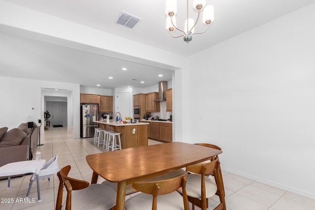 dining area featuring an inviting chandelier, light tile patterned floors, and sink