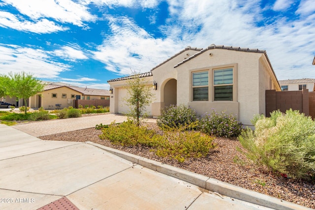 mediterranean / spanish-style home featuring a garage