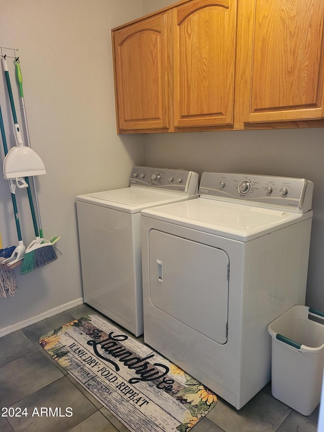 laundry room featuring cabinets and separate washer and dryer