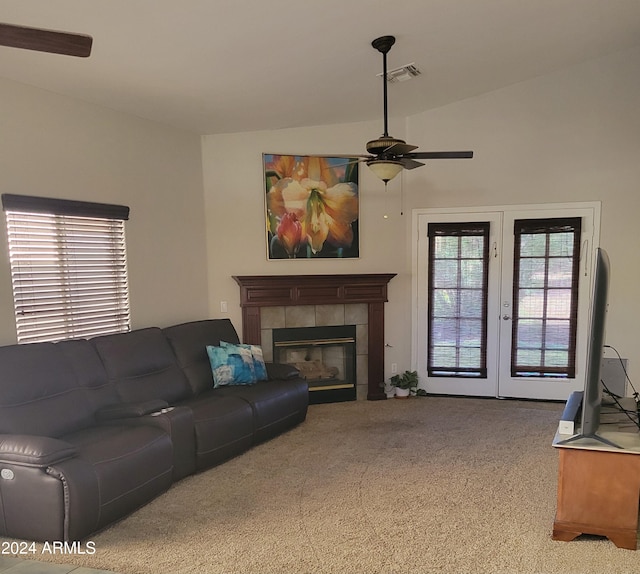 living room with a fireplace, french doors, light colored carpet, vaulted ceiling, and ceiling fan