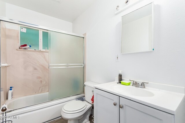 full bathroom with vanity, toilet, and bath / shower combo with glass door