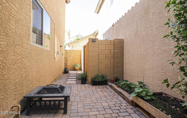 1950 W Park Pl, Chandler, AZ 85224 - view of side of property featuring stucco siding, a patio area, a fenced backyard, and a fire pit