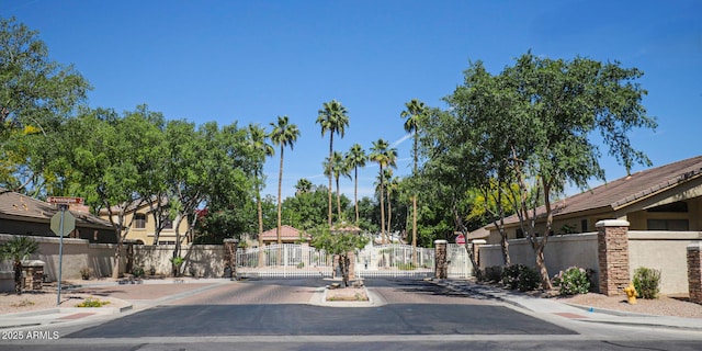 1950 W Park Pl, Chandler, AZ 85224 - view of asphalt road with a gate, curbs, sidewalks, a gated entry, and traffic signs