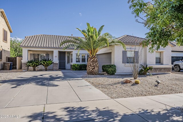 19323 E Canary Way, Queen Creek, AZ 85142 - view of front facade featuring a garage, stucco siding, a tile roof, stone siding, and concrete driveway