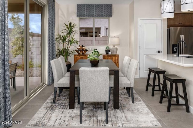 dining room with sink and light tile patterned floors