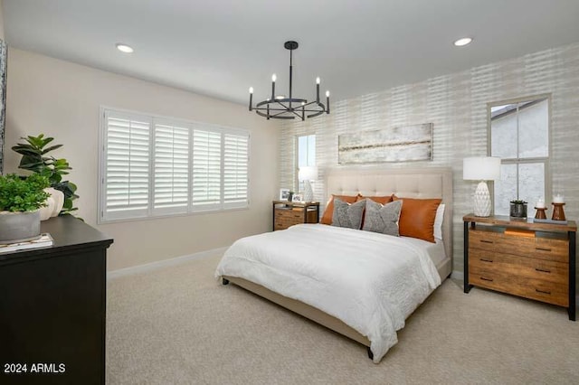 carpeted bedroom with a notable chandelier