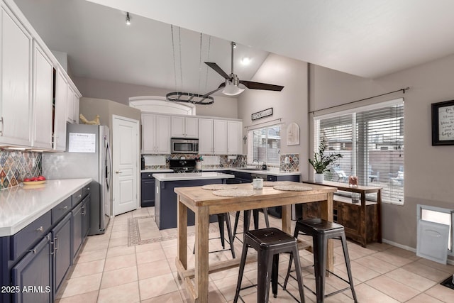 kitchen with white cabinetry, sink, decorative backsplash, and stainless steel appliances