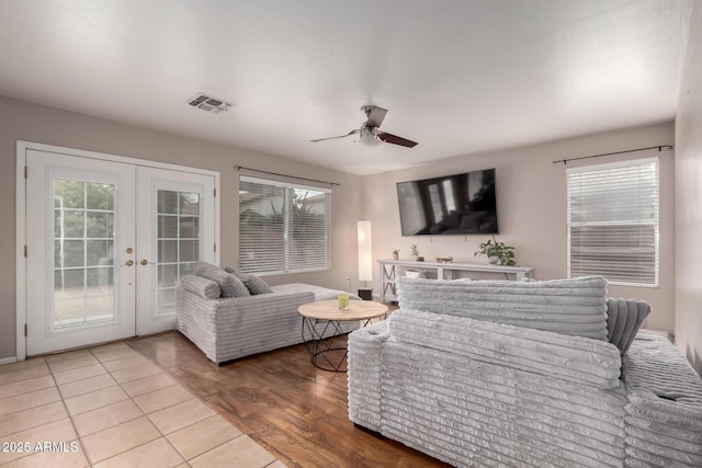 living room featuring wood-type flooring, plenty of natural light, and french doors