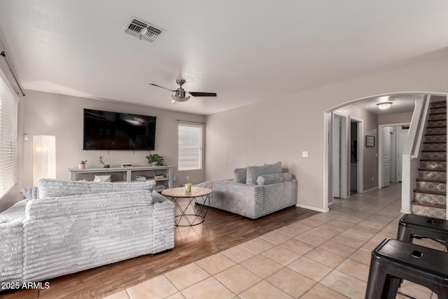 living room with ceiling fan and light tile patterned floors