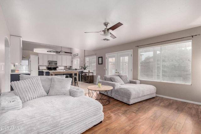 living room with french doors, ceiling fan, and hardwood / wood-style floors