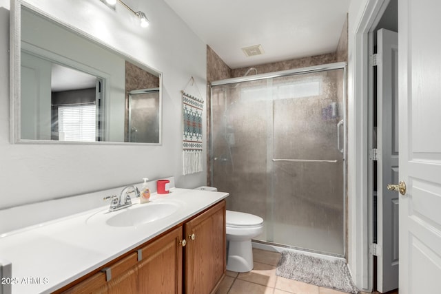 bathroom featuring tile patterned flooring, vanity, an enclosed shower, and toilet