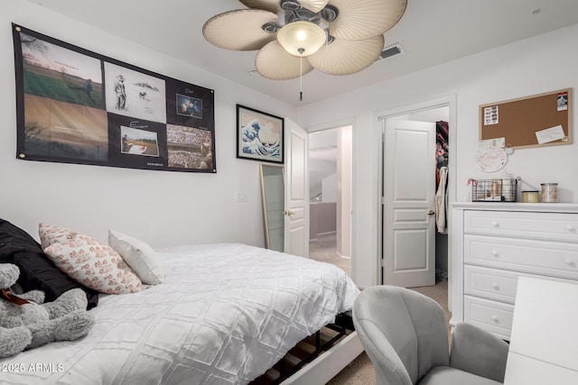 bedroom with ceiling fan, light colored carpet, a spacious closet, and a closet