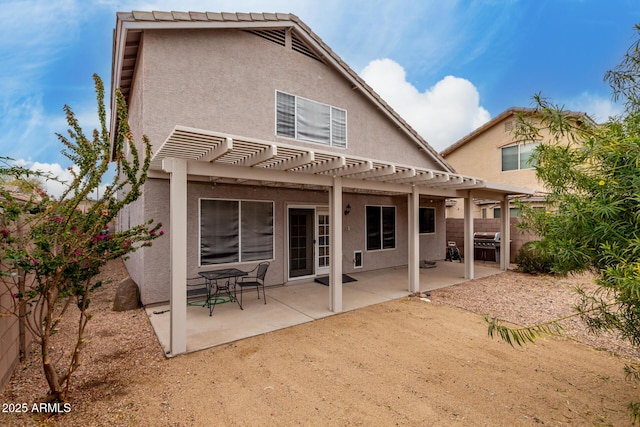 back of property featuring a patio area and a pergola