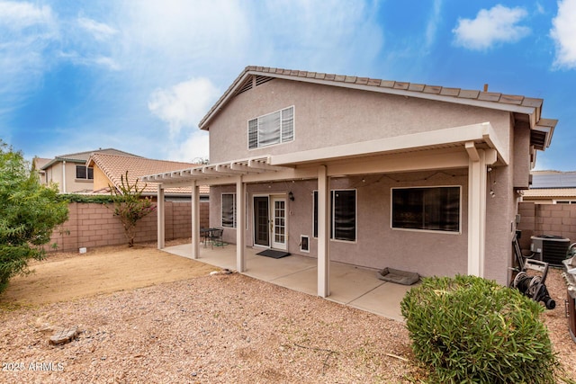 back of property featuring central AC, a pergola, and a patio area