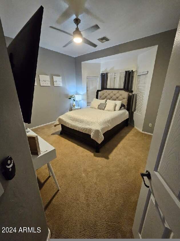 carpeted bedroom featuring ceiling fan