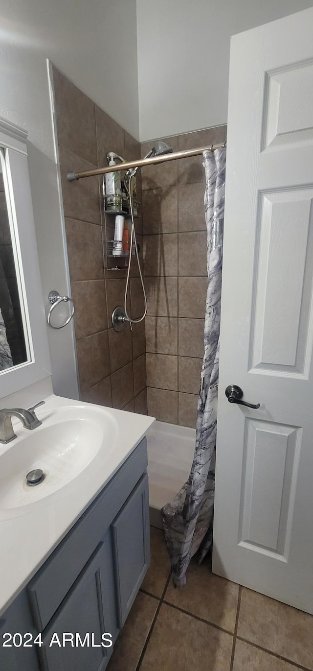 bathroom featuring tile patterned flooring, a shower with curtain, and vanity