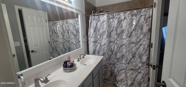 bathroom featuring vanity and a shower with shower curtain