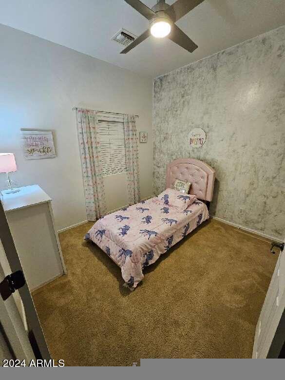 unfurnished bedroom featuring carpet flooring and ceiling fan