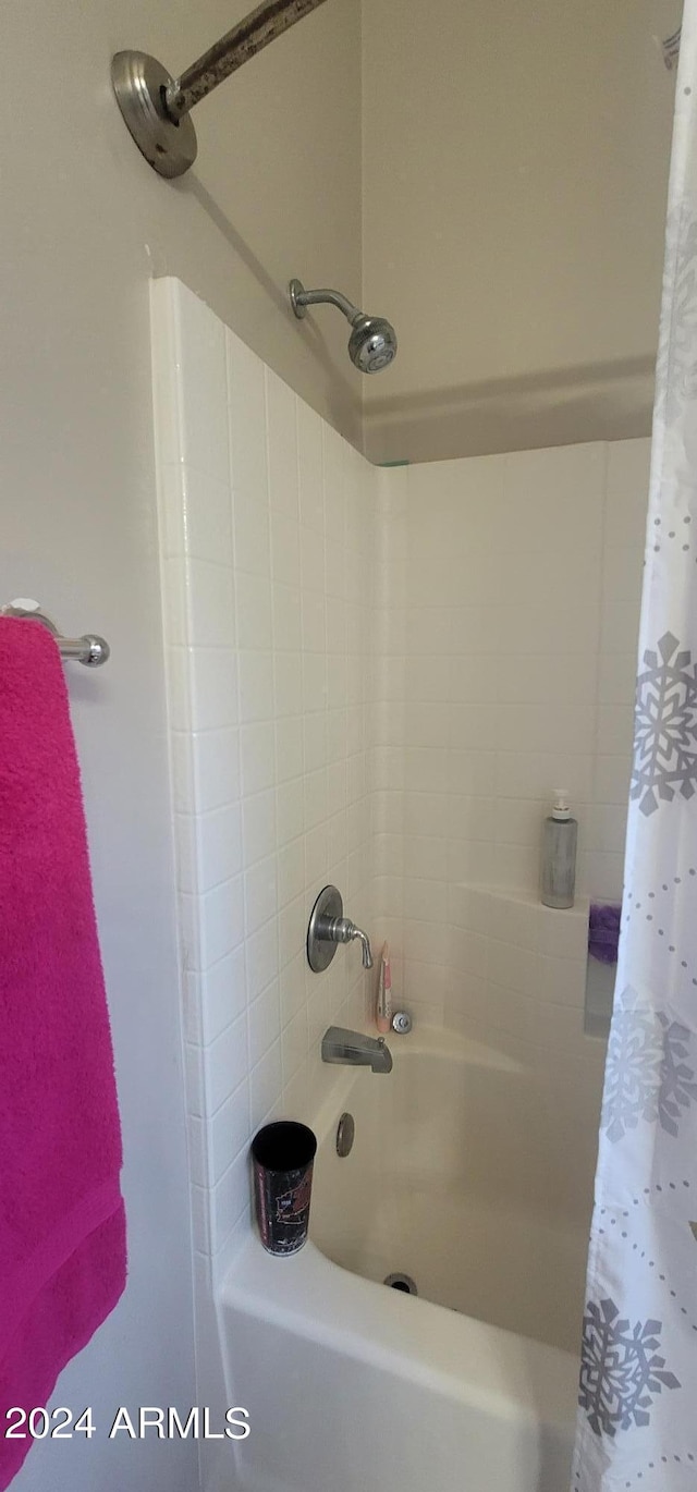 bathroom with shower / bath combo with shower curtain