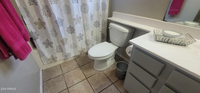 bathroom with tile patterned flooring, a shower with curtain, vanity, and toilet