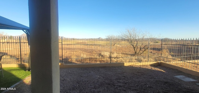 view of yard with a rural view