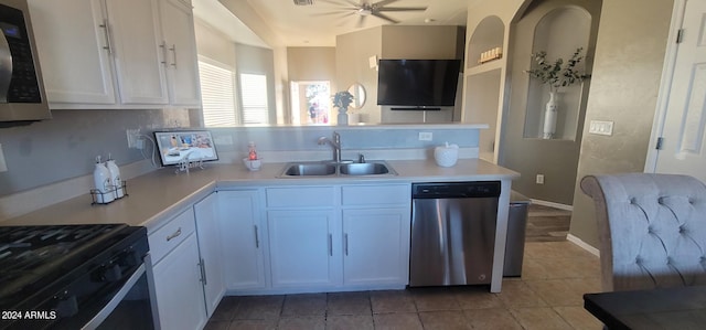 kitchen with appliances with stainless steel finishes, tile patterned floors, ceiling fan, sink, and white cabinets