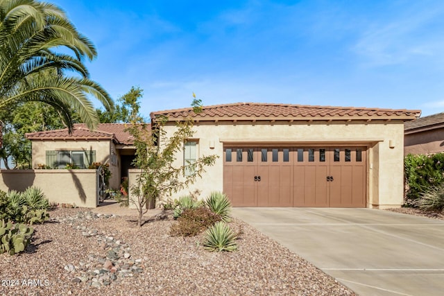 mediterranean / spanish-style home featuring a garage