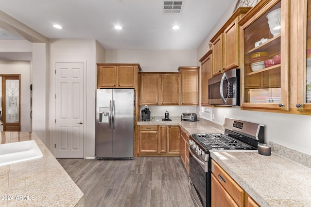 kitchen with sink, stainless steel appliances, and dark hardwood / wood-style floors