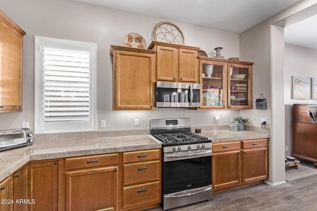 kitchen featuring stainless steel appliances and dark wood-type flooring