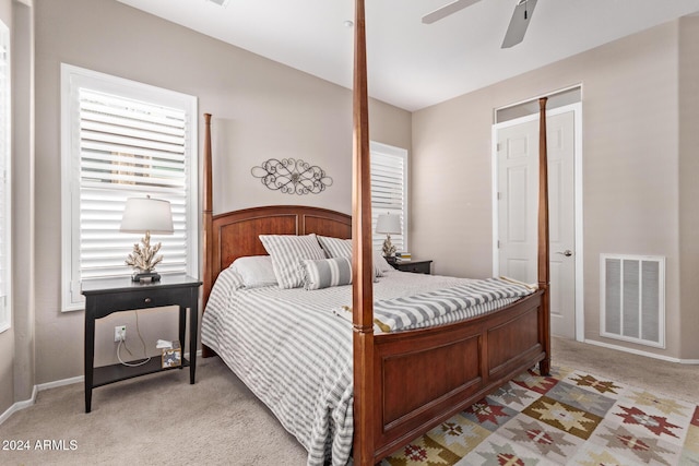 bedroom with ceiling fan, a closet, and light carpet