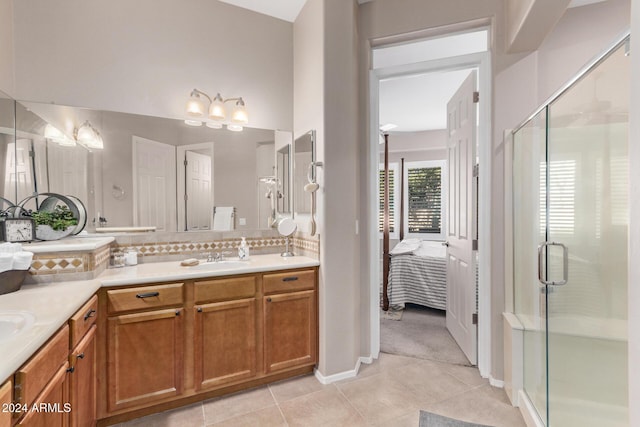 bathroom with tile patterned flooring, vanity, and an enclosed shower